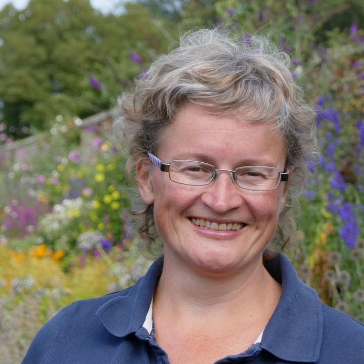Rachael Kennard-Wall smiling in a flowery garden